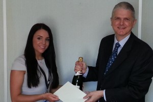 Alissia Grist receives her prize from Crane & Staples Office Manager, Alistair Williams.